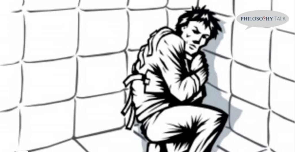 Man in straitjacket, seated in padded cell, illustrating the insanity defense.